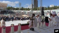 Pope Francis (R) holds his pastoral staff as he celebrates a Mass in a partially empty Tbilisi stadium, in Tbilisi, Georgia, Oct. 1, 2016. The pontiff will next visit Azerbaijan during his three-day visit to the Caucasus.