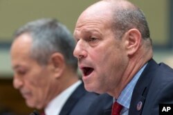 Leon Rodriguez, director of U.S. Citizenship and Immigration Services at the Homeland Security Department, right, testifies on Capitol Hill in Washington on Dec. 17, 2015.