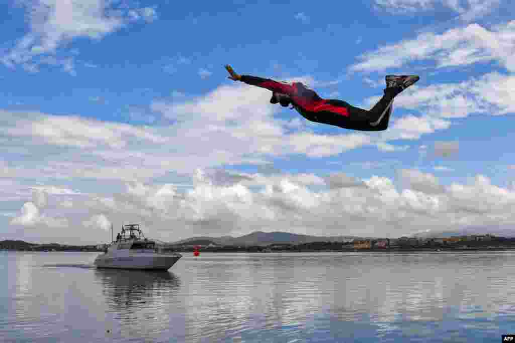 French driver Sebastien Ogier dives in the port of Olbia, Italy, after winning the Rally of Sardegna, 5th round of the FIA World Rally Championship.