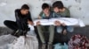 Twenty-year-old Ali Assaf, center, reportedly the only person in his family to survive an overnight Israeli airstrike in the Jabalia refugee camp in the northern Gaza Strip, is comforted as he mourns near the bodies of his relatives, Oct. 12, 2024. 