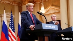 Russia's President Vladimir Putin gestures during a joint news conference with U.S. President Donald Trump after their meeting in Helsinki, Finland, July 16, 2018.
