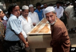 FILE - Bangladeshi Muslims carry the body of Xulhaz Mannan for his funeral in Dhaka, Bangladesh, April 26, 2016.