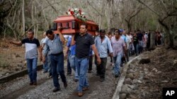 Members of the Solecito search group carry the coffin of Pedro Huesca, a police detective who disappeared in 2013 and whose body was recently found in a mass grave, as they walk to the cemetery in Palmas de Abajo, Veracruz, Mexico, March 8, 2017. Huesca's remains are part of a collection of more than 250 skulls found over the last several months in what appears to be a drug cartel mass burial ground on the outskirts of the city of Veracruz, prosecutors said Tuesday.