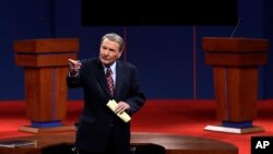 This Oct. 3, 2012 file photo shows moderator Jim Lehrer addressing the audience before the first presidential debate at the University of Denver in Denver. 