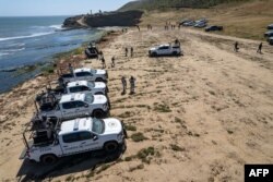 FILE—National Guard vehicles guard a state prosecutors search at the site where three surfers were camping before disappearing last week, as the investigation continues in El Faro, Santo Tomas delegation in Ensenada, Baja California state, Mexico, on May 6, 2024.