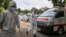 ရန်ကုန်မြို့ရှိ Quarantine Center တခုတွင် ကိုဗစ်သံသယရှိလူနာစာရင်းကို စစ်ဆေးနေသည့် PPE ဝတ်စုံဝတ် ပရဟိတလုပ်သားများ။ (အောက်တိုဘာ ၁၊ ၂၀၂၀)