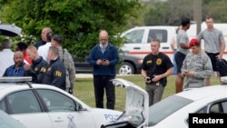 Military and law enforcement personnel are seen inside Joint Base San Antonio-Lackland, in San Antonio, April 8, 2016. Two people were killed in an apparent murder-suicide at the base on Friday, which triggered a lockdown at the facility.