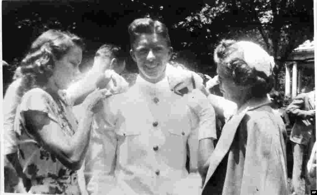 In this undated file photo, Jimmy Carter gets his bar pinned by his wife Rosalynn, left, and his mother Lillian Carter at the U.S. Naval Academy. 