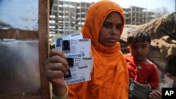 အိန္ဒိယနိုင်ငံ Jammu မြို့မှာ UNHCR အသိအမှတ်ပြုကတ် ထုတ်ပြနေတဲ့ ရိုဟင်ဂျာအမျိုးသမီးတဦး။ (မတ် ၉၊ ၂၀၂၁)