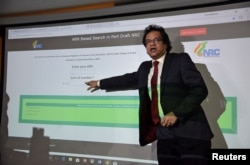 FILE - Prateek Hajela, Assam's chief co-coordinator of the National Register of Citizens (NRC), demonstrates how to check a name online on its website after the publication of the first draft of the NRC in Guwahati city in the northeastern state of Assam,