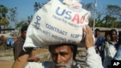 A Bangladeshi man receives food aid from USAID following Cyclone Sidr in 2007.