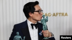 Ke Huy Quan poses with the awards for Outstanding Performance by a Male Actor in a Supporting Role and Outstanding Performance by a Cast in a Motion Picture for “Everything Everywhere All at Once” during the 29th Screen Actors Guild Awards in Los Angeles, California, Feb. 26, 2023.