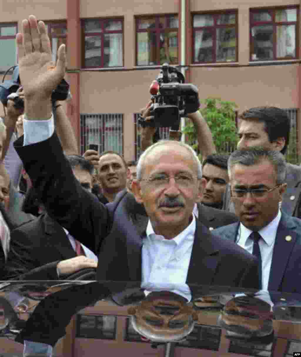 Kemal Kilicdaroglu, the leader of Turkey's main opposition Republican People's Party reacst to cheering supporters after he voted at a polling station in Ankara, Turkey, Sunday, June 12, 2011. Turkey's ruling party sought a third term in elections Sunday,