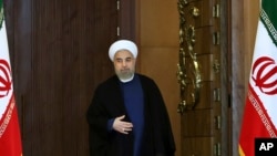 FILE - Iran's President Hassan Rouhani arrives for an address to the nation after a nuclear agreement was announced in Vienna, in Tehran, Iran, July 14, 2015.