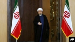 FILE - Iran's President Hassan Rouhani arrives for an address to the nation after a nuclear agreement was announced in Vienna, in Tehran, Iran, July 14, 2015.