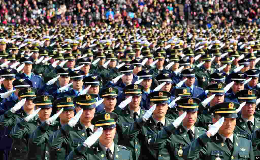 New South Korean military officers salute during the joint commission ceremony of over 5,000 new military officers of the Army, Navy, Air Force and Marines at the military headquarters in Gyeryong, south of Seoul.