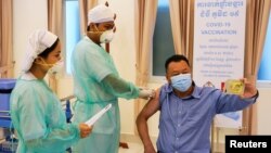 A man receives a vaccine as Cambodia starts its coronavirus disease (COVID-19) vaccine rollout with 600,000 doses of Sinopharm vaccine donated by China in Phnom Penh, Cambodia, February 10, 2021. (REUTERS/Cindy Liu)