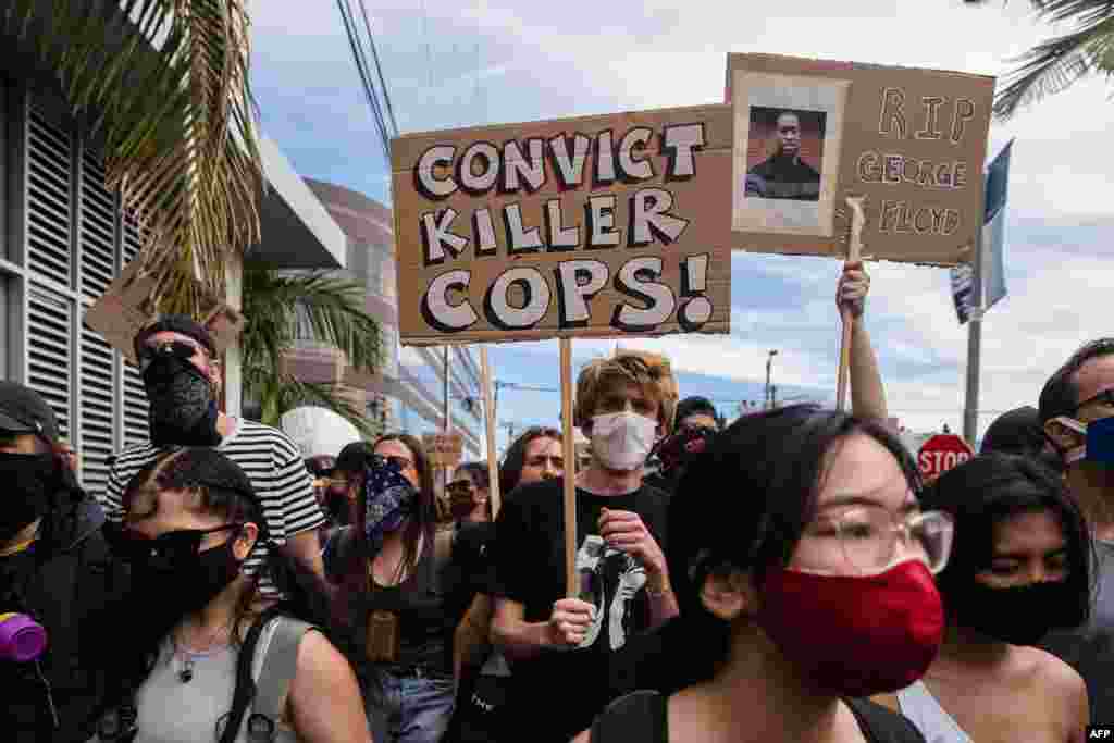 Demonstrators march to protest against the death of George Floyd, an unarmed black man who died while while being arrested and pinned to the ground by the knee of a Minneapolis police officer, along a street in Los Angeles on May 30, 2020. 