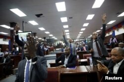 Haitian deputies ask for the floor after the speech of appointed Prime Minister Fritz William Michel to present his general policy at the Parliament in Port-au-Prince, Haiti, September 3, 2019.