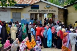 FILE - Locals line up to cast vote in Zanzibar, Tanzania, Oct. 28, 2020.