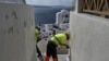 Municipal employees place caution tape to restrict access for tourists due to recent seismic activities in Oia village on the Greek island of Santorini, Feb. 5, 2025. 