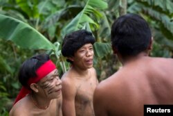 Yanomami Indians chat at the community of Irotatheri, during a government trip for journalists, in the southern Amazonas state of Venezuela, just 19km (12 miles) from Brazil's border, Sept. 7, 2012.
