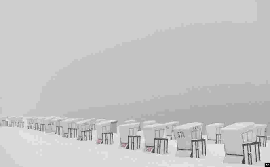 Snow-covered beach chairs stand at the lido of Strandbad Wannsee in Berlin, Germany. Bathing season at the lido traditionally starts on Good Friday. 