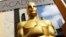 FILE - An Oscar statue appears outside the Dolby Theatre for the Academy Awards in Los Angeles, Feb. 21, 2015.