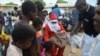 Santa Clause shares sweets and other gifts with students (VOA/L. Masina)