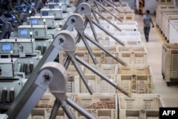 An worker  passes by baskets afloat  of corks astatine  the Amorim cork mill  successful  Mozelos, adjacent   Santa Maria da Feira, northbound  of Portugal connected  Sept. 10, 2024.