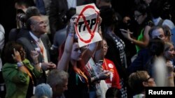 A delegate holds an anti-Trans-Pacific Partnership (TPP) trade agreement sign during the first day of the Democratic National Convention in Philadelphia, July 25, 2016. 