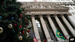A giant Christmas tree is erected outside the New York Stock Exchange, Nov. 30, 2021, in New York. 