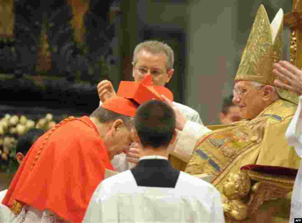 In this picture made available Monday, Nov. 22, 2010 by the Vatican newspaper Osservatore Romano, Newly-elevated Cardinal Raymond Leo Burke, of the US, left, receives a parchment and his red three-cornered biretta hat by Pope Benedict XVI during a consist