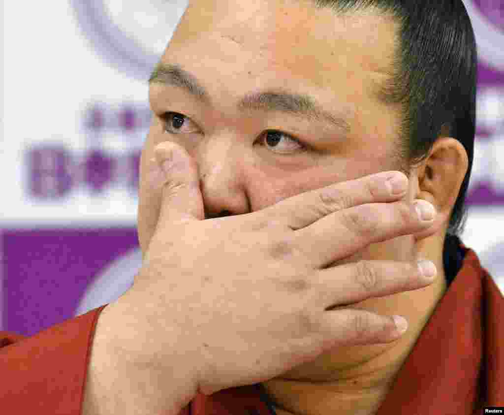 Sumo grand champion Kisenosato wipes his tears as he attends his retirement news conference in Tokyo, Japan, in this photo taken by Kyodo.