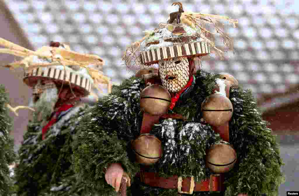 Men dressed as &quot;Chlaeuse,&quot; figures that scare away evil spirits, carrying round bells and cowbells, are seen during the traditional &quot;Sylvesterchlausen&quot; near the northeastern village of Urnaesch, Switzerland.