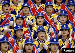 FILE - North Korean women cheer their men's basketball team during a game against the Philippines at the 14th Asian Games in Pusan, South Korea.