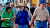 In this photo taken November 21, 2009 released by Habitat for Humanity, former U.S. President Jimmy Carter, right, holds the hand of his wife Rosalynn as they visit the Damnak Thom village where Habitat for Humanity volunteers built 21 houses, file photo. 