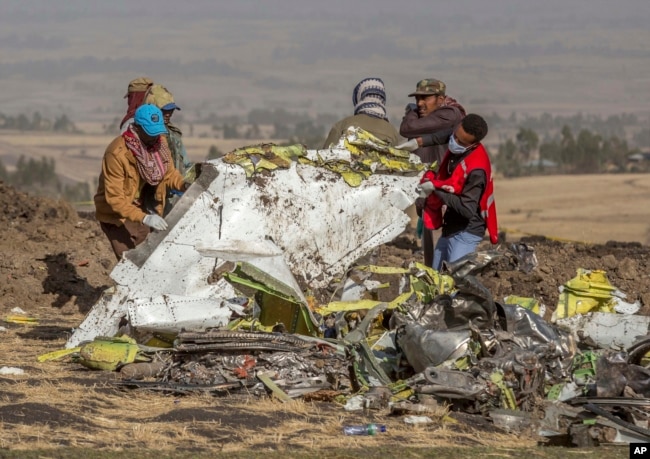 FILE - In this file photo dated Monday, March 11, 2019, rescuers work at the scene of an Ethiopian Airlines' Boeing 737 MAX plane crash south of Addis Ababa, Ethiopia. (AP Photo/Mulugeta Ayene, FILE)