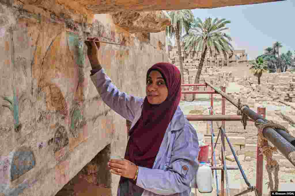 Egyptian archaeological worker Fatma says &ldquo;restoring the painting colors, will take years,&rdquo; in Karnak temple in Luxor, Egypt, April 20, 2018.