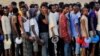 Ethiopian men who fled war in the Tigray region queue for food at the Um-Rakoba camp, on the Sudan-Ethiopia, November 19, 2020.