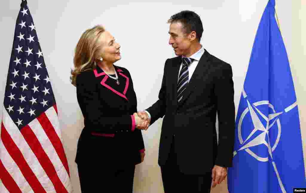 U.S. Secretary of State Hillary Clinton (L) shakes hands with NATO Secretary-General Anders Fogh Rasmussen at the NATO headquarters in Brussels December 4. 