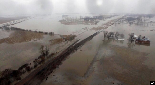 FILE - This aerial photo shows flooding along the Missouri River in Pacific Junction, Iowa, March 19, 2019.