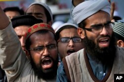 FILE - Pakistani students of Islamic seminaries chant slogans during a rally in support of blasphemy laws, in Islamabad, Pakistan, March 8, 2017.