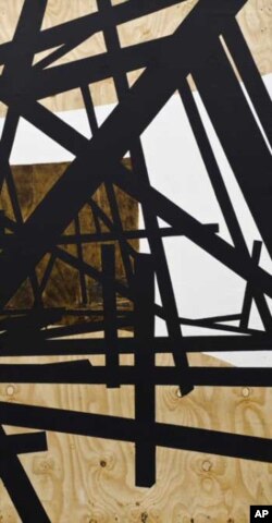 Nitegeka has created his latest work from dark and angular wooden beams
