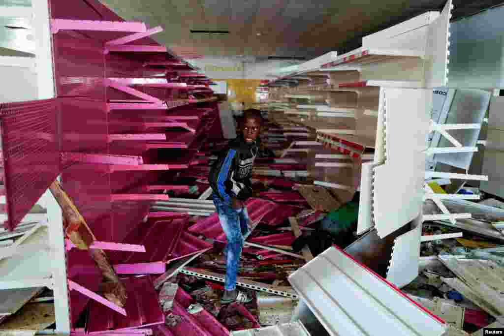 A boy is pictured inside a ransacked supermarket, after opposition leader Ousmane Sonko was arrested following sexual assault accusations, in Dakar, Senegal.