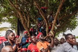 Supporters of Bobi Wine look on as he speaks at a news conference at his home in Kasangati, Kampala, Uganda, July 24, 2019.