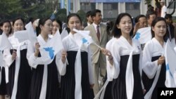 In this 2005 photo, North Korea's female cheerleaders, including a woman (right) believed to be North Korean leader Kim Jong-Un's current wife Ri Sol-Ju, attend the 2005 Asian Athletics Championships in Incheon.