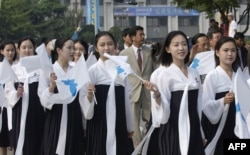 In this 2005 photo, North Korea's female cheerleaders, including a woman (right) believed to be North Korean leader Kim Jong-Un's current wife Ri Sol-Ju, attend the 2005 Asian Athletics Championships in Incheon.