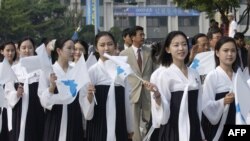 FILE - North Korea's female cheerleaders, including a woman (right) believed to be North Korean leader Kim Jong-Un's current wife Ri Sol-Ju, attend the 2005 Asian Athletics Championships in Incheon.