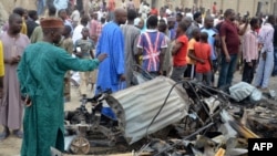 People look at the damages after two explosions rocked a crowded neighborhood of Nigeria's restless northeastern city of Maiduguri, a stronghold of Boko Haram, on March 2, 2014.